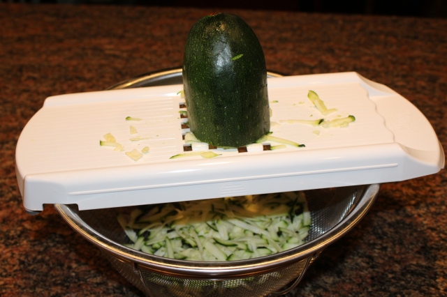 Grate zucchini with Pampered Chef Veggie Strip Maker